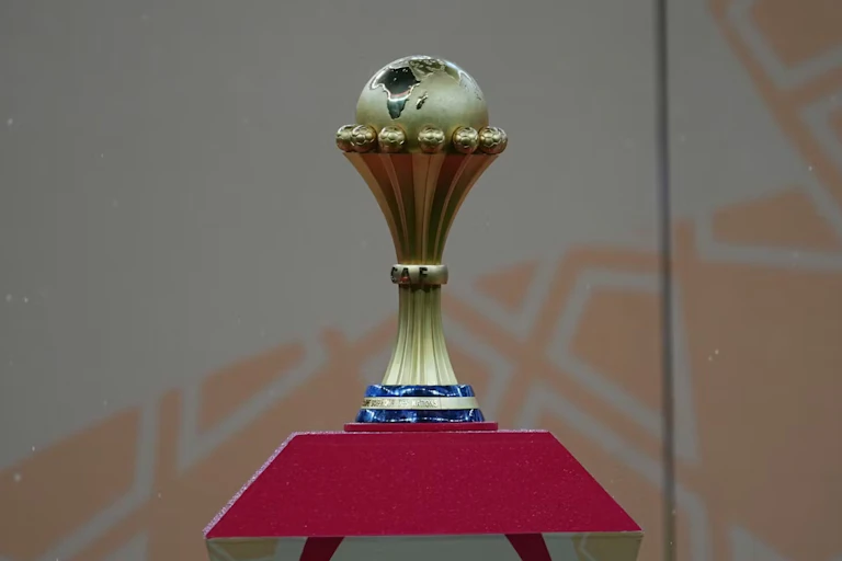 A football trophy featuring a globe cradled with the map of Africa prominent.