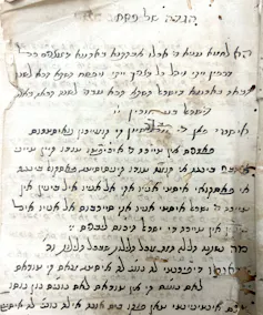 A piece of paper filled with black script in Ladino in the Hebrew alphabet.