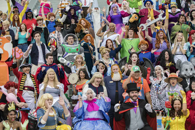 A large number of Disney cosplayers – dressed in outfits ranging from Buzz Lightyear to Captain Hook – pose for a group photo.