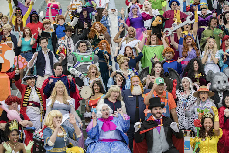 A large number of Disney cosplayers – dressed in outfits ranging from Buzz Lightyear to Captain Hook – pose for a group photo.
