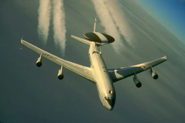 a four-engine jet aircraft with a large disk mounted on the rear of the fuselage in flight