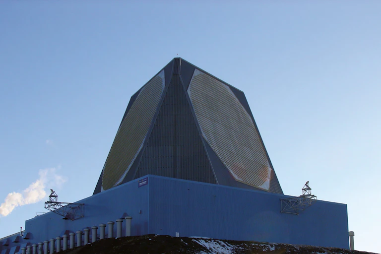 a large outdoor structure with angled sides containing octagonal patterns