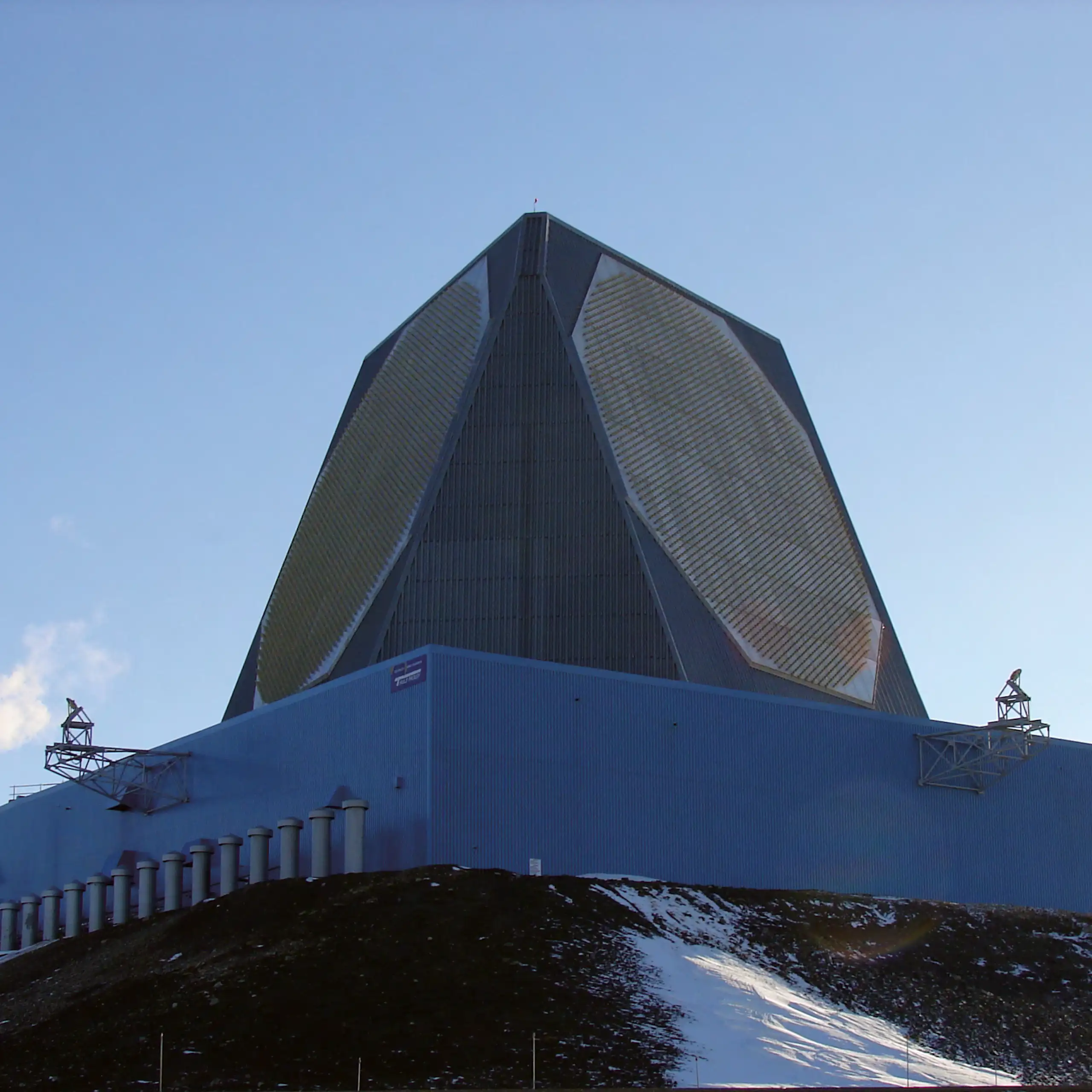 a large outdoor structure with angled sides containing octagonal patterns
