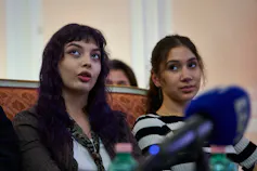 Two teenaged girls with dark hair.