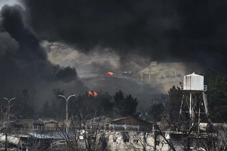 Oil tanks and fire amid billowing black smoke