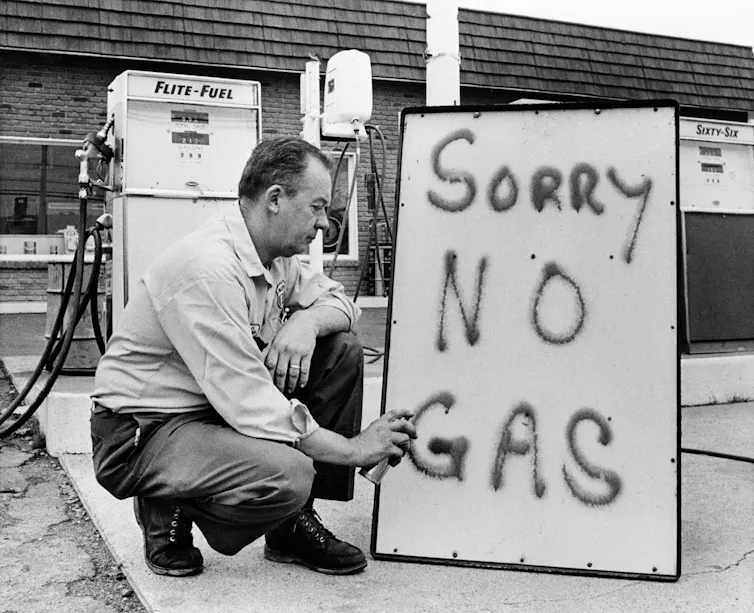A gas station in 1973, lets customers know he is out of gas.