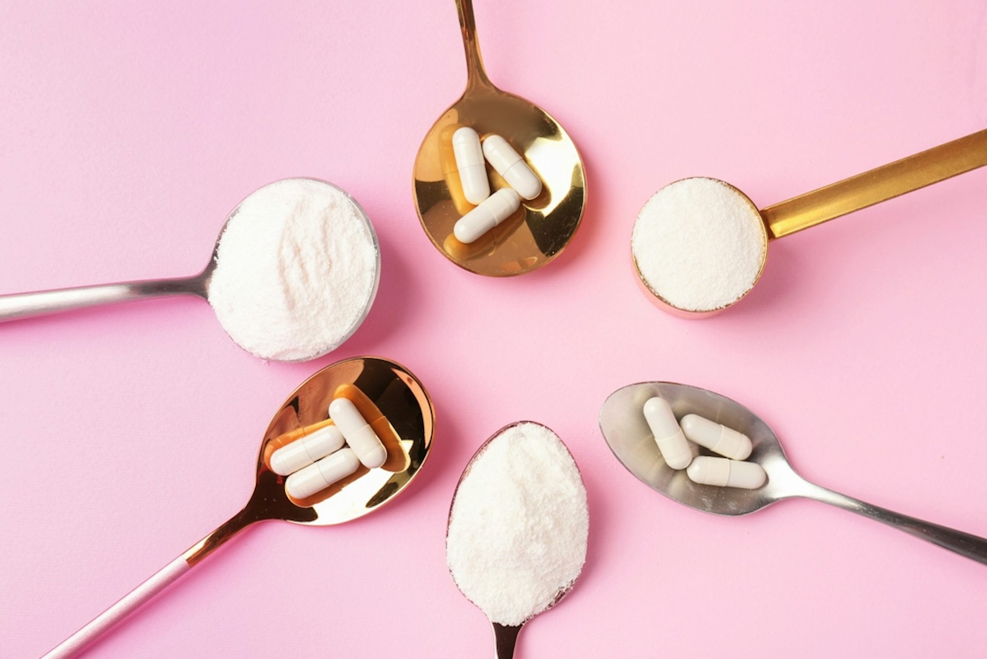 Various collagen supplements against a pink background.