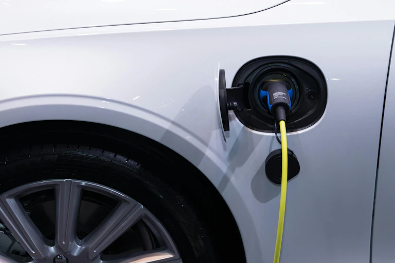 A charging plug going into an EV.