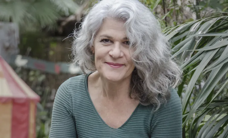 a smiling woman with grey hair