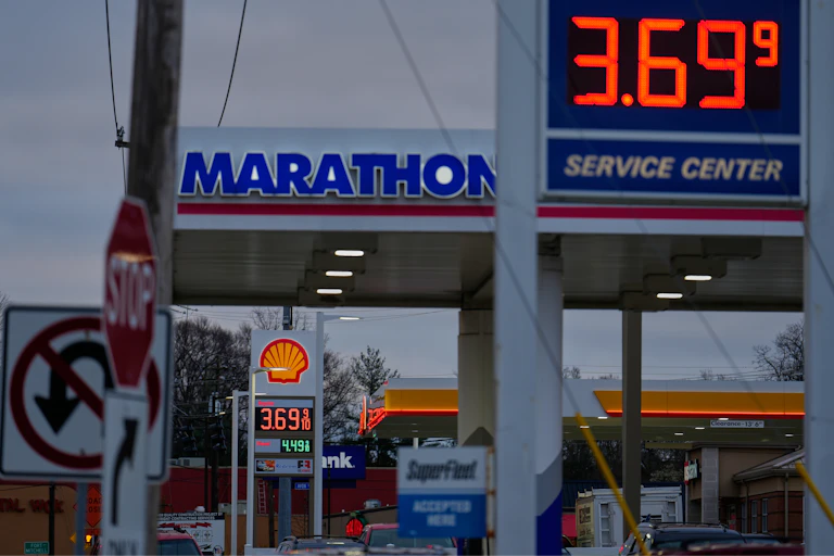 Two gas stations next to each other advertise prices of $3.69 per gallon.