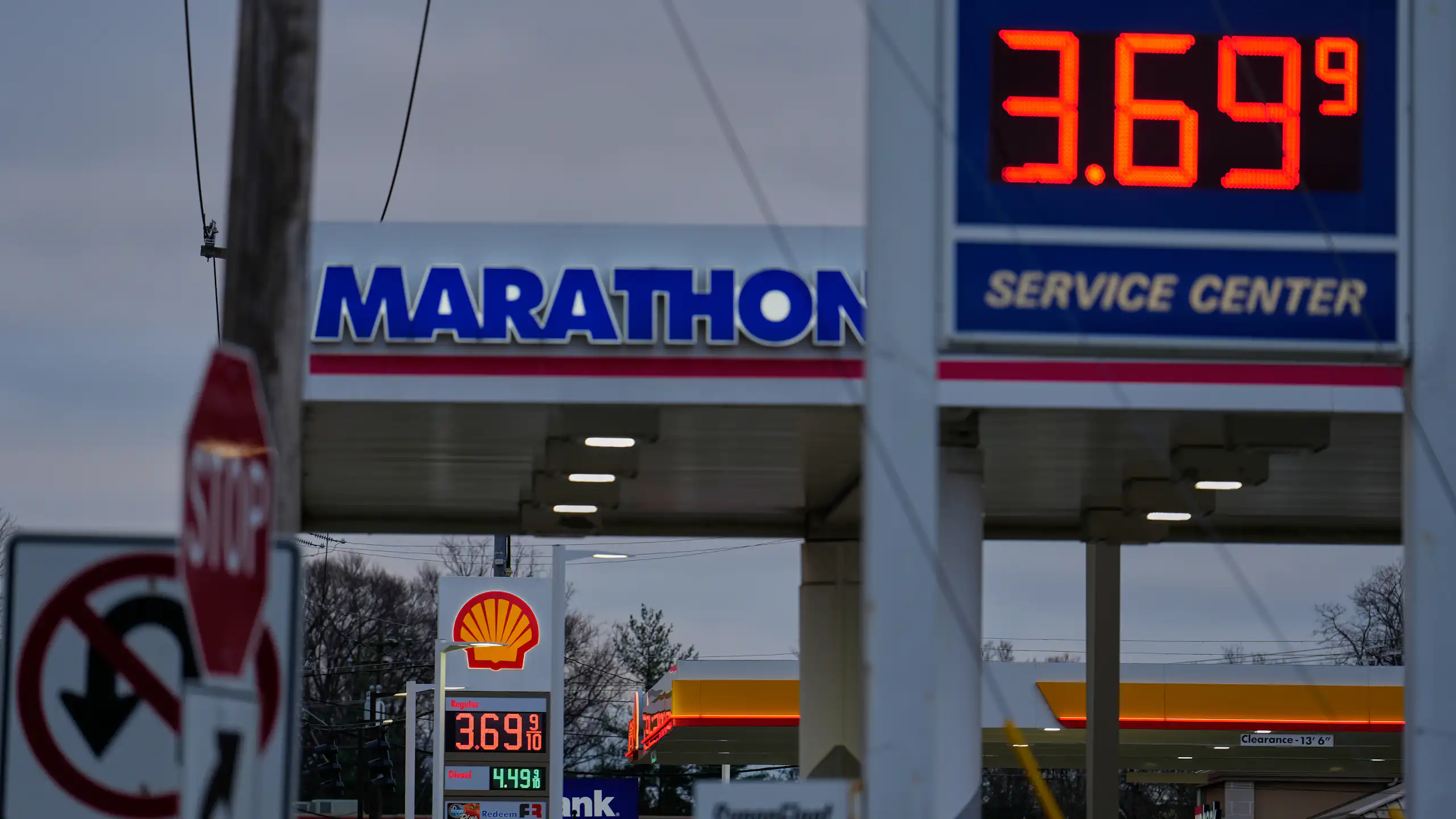 Two gas stations next to each other advertise prices of $3.69 per gallon.