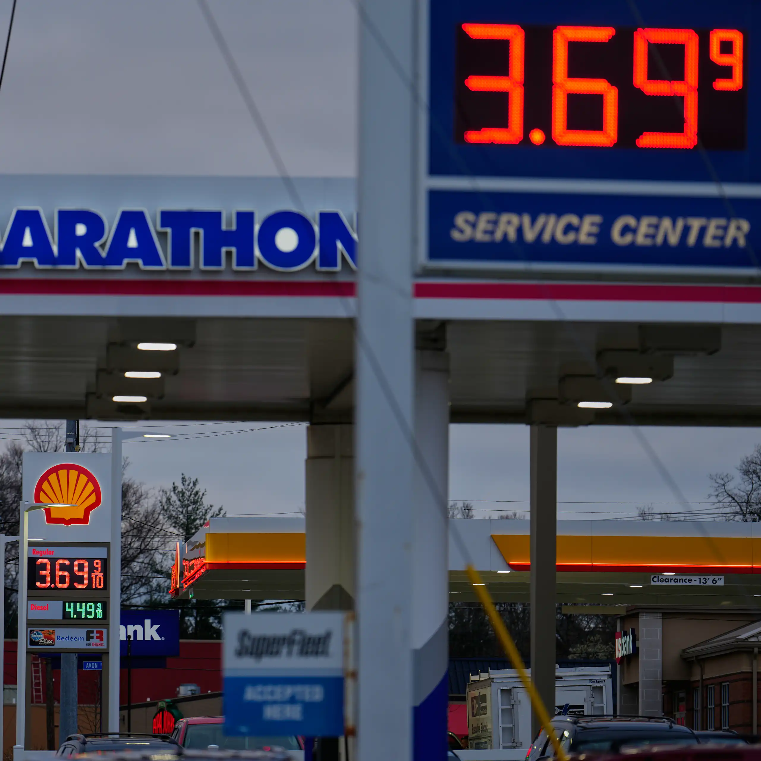Two gas stations next to each other advertise prices of $3.69 per gallon.