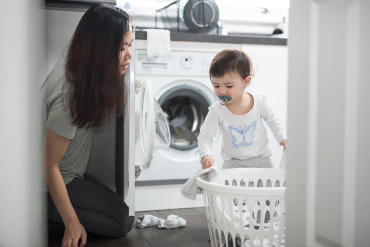 woman and toddler doing laundry