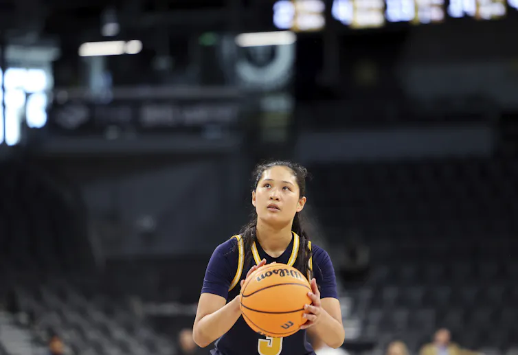 Sumayah Sugapong holding basketball on the court, eyes on the off-screen basket as she prepares for a free throw