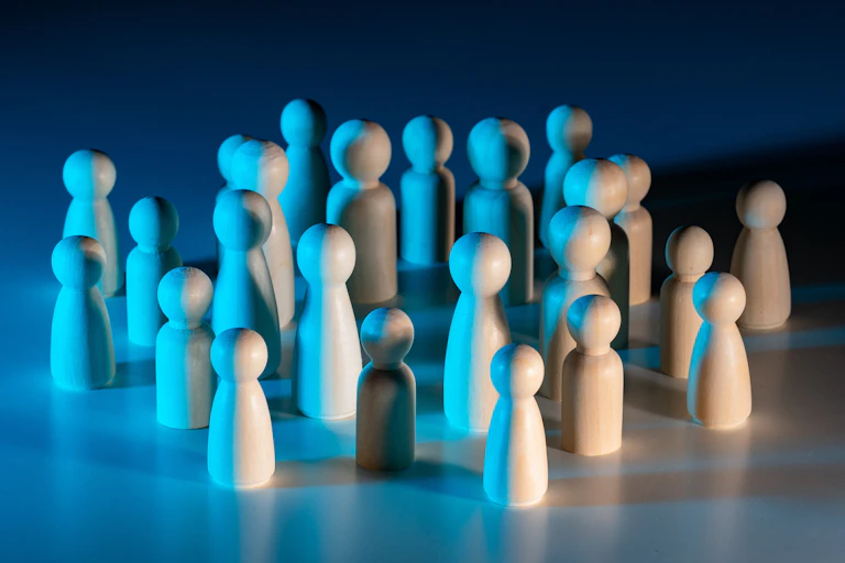 Group of wooden figures under blue lighting