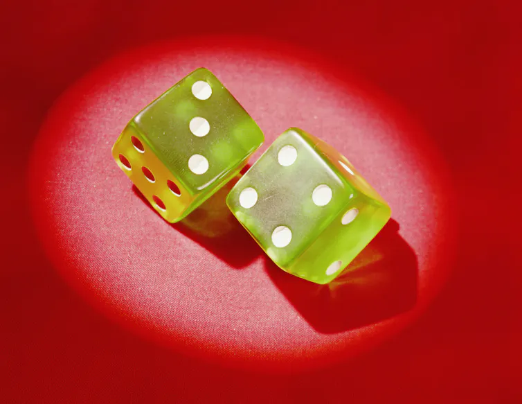 Two bright green dice fall on a red backdrop, showing the numbers three and four.