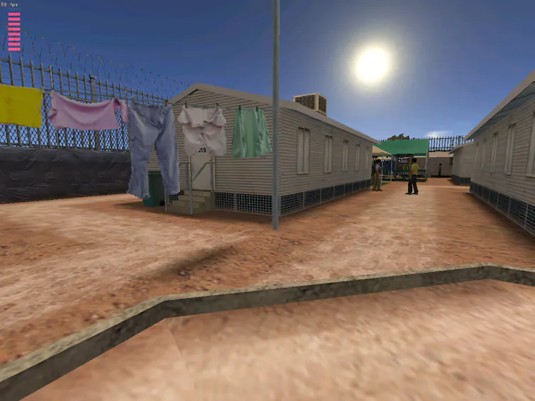 A screenshot from a 3D video game shows a dirt courtyard. In the scene, we see clothes hanging on a wire, a white building and some figures in the distance.