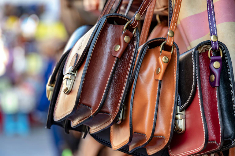 Close-up of three small handbags that appear to be made from leather.