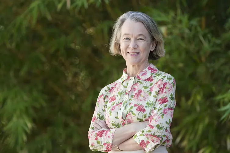 a grey-haired, elegant women in a floral shirt