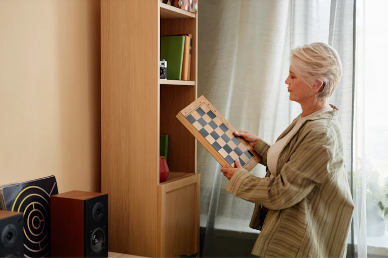 A woman looking at a chess board