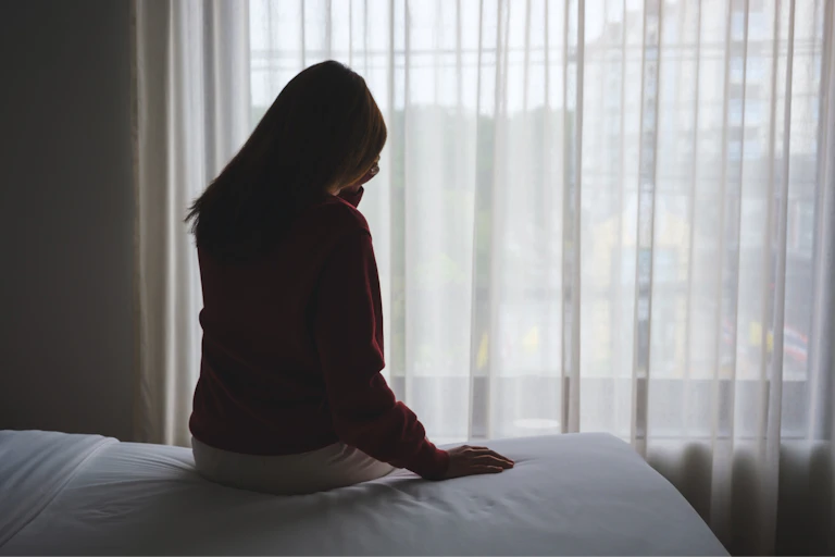 Silhouette crying woman back turned