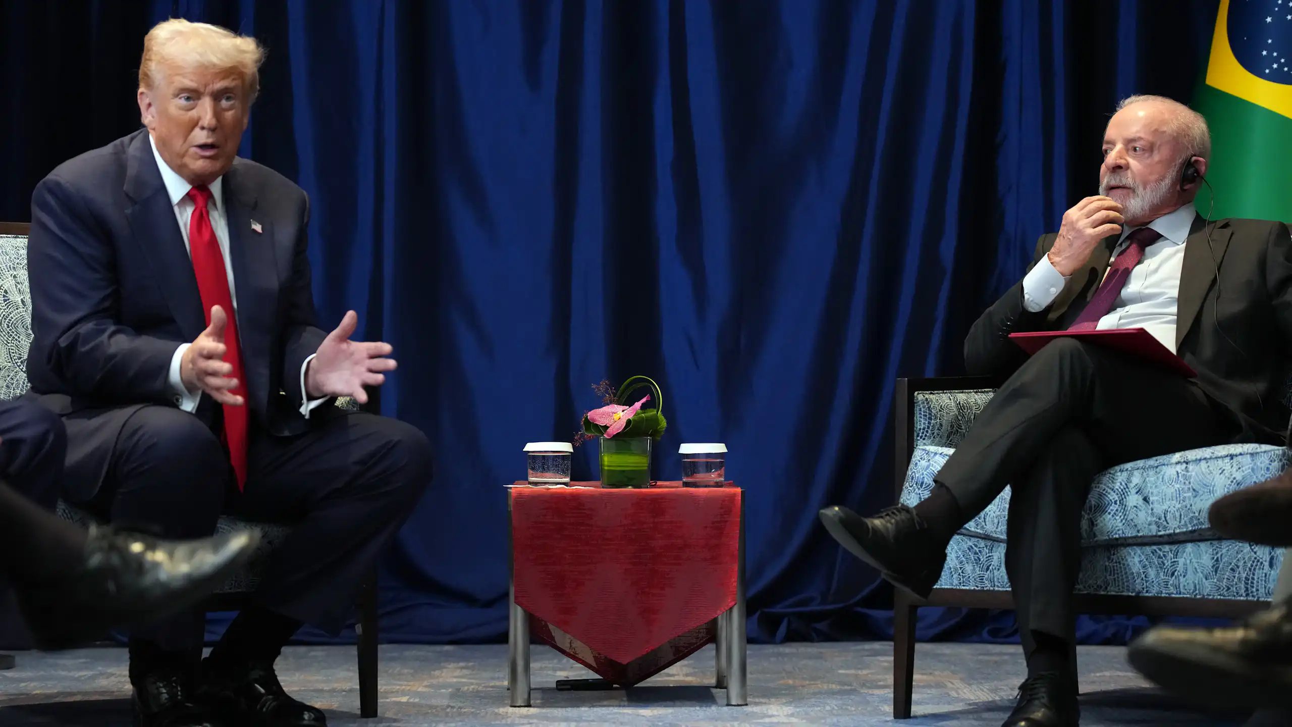Two men sit at a small table.