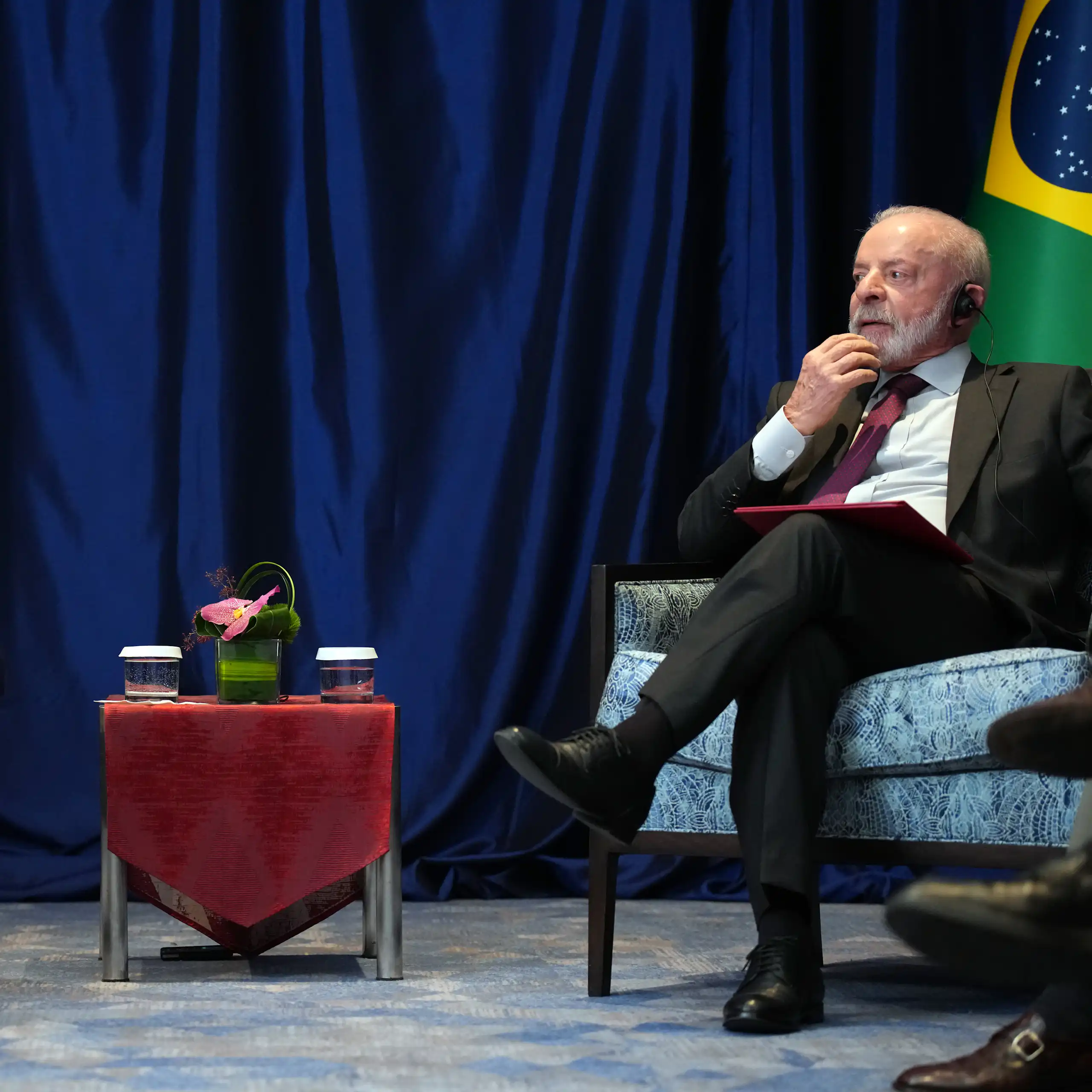 Two men sit at a small table.