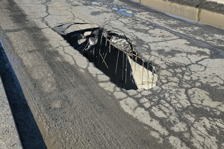 A gaping hole on a bridge