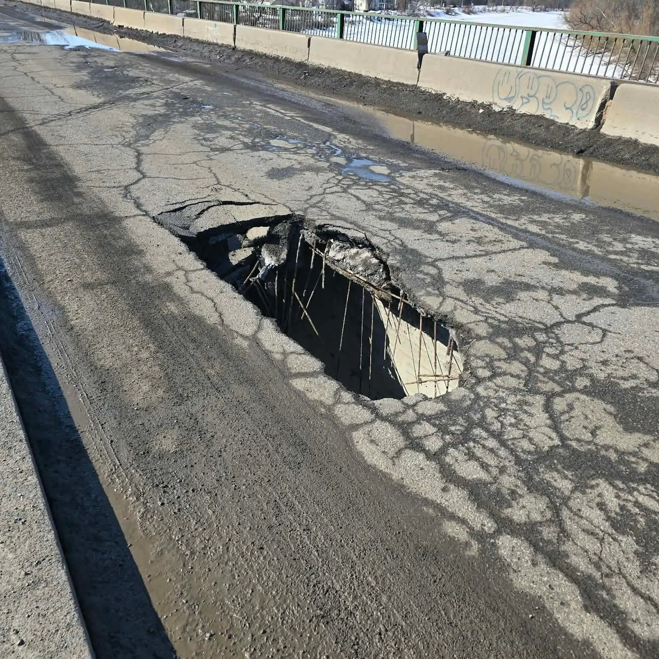 A gaping hole on a bridge