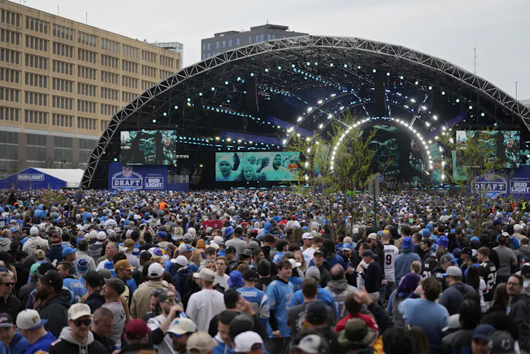 An overhead shot of a crowd filling an outdoor stage.