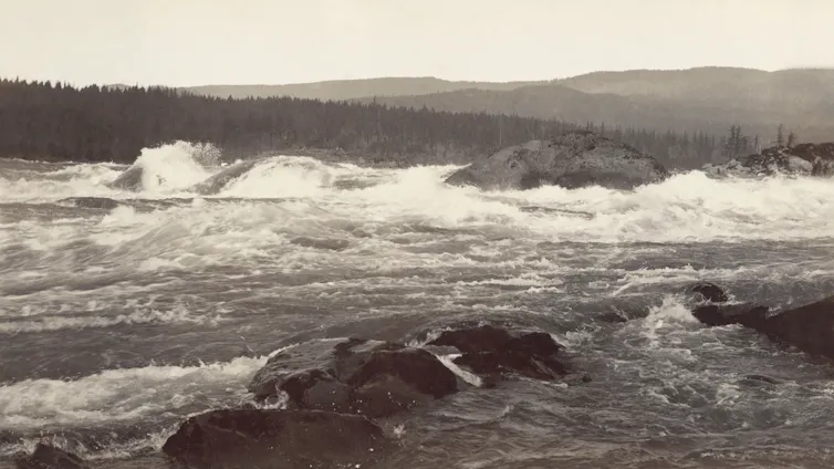 An old photo of a river with rushing rapids