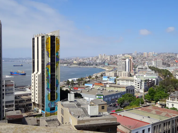 A city with highrises and other buildings near a bay