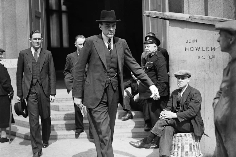 Black and white photo of Reith leaving Wesminster Abbey after overseeing broadcast arrangements for the 1937 coronation service