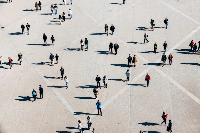 An aerial shot of people and their shadows.