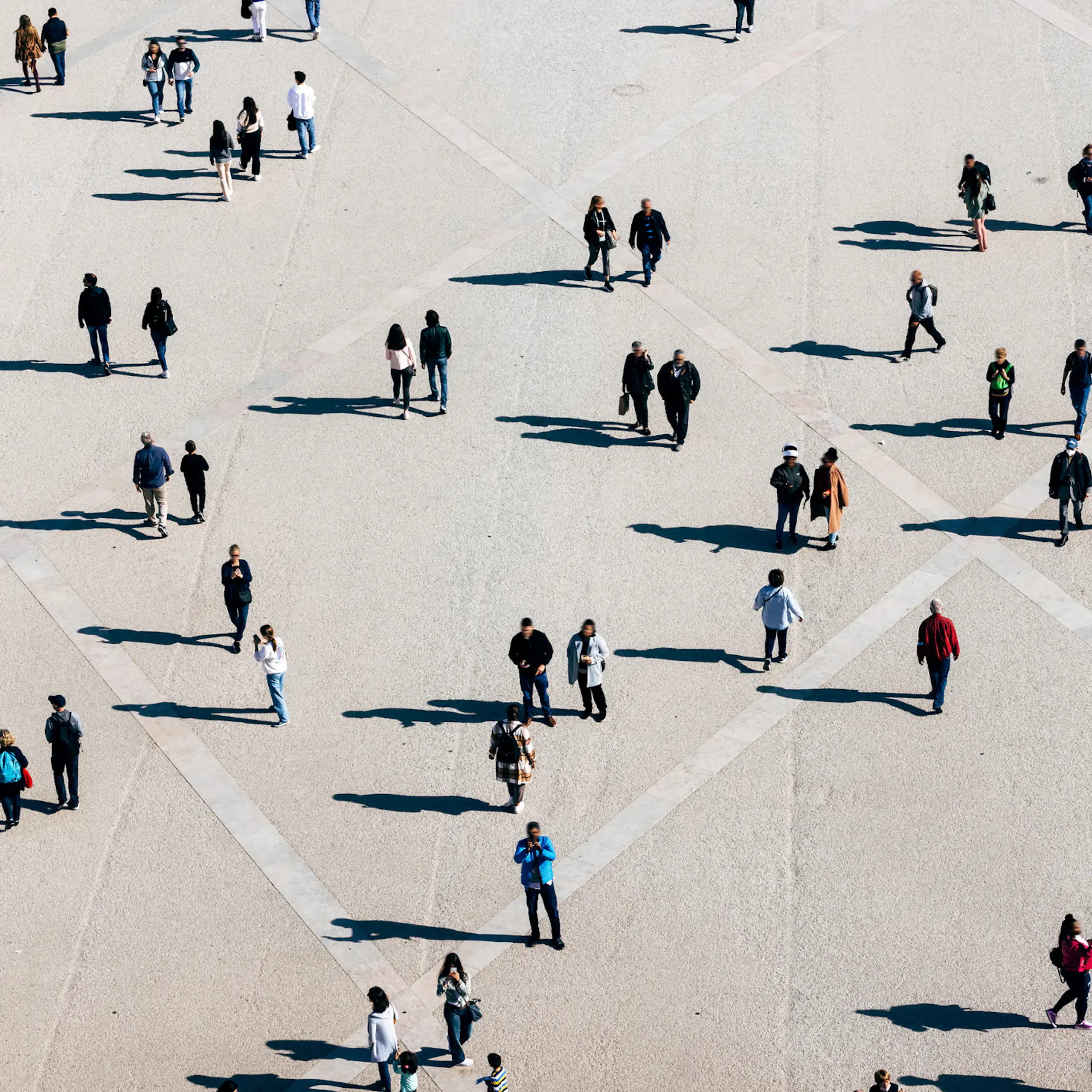 An aerial shot of people and their shadows.