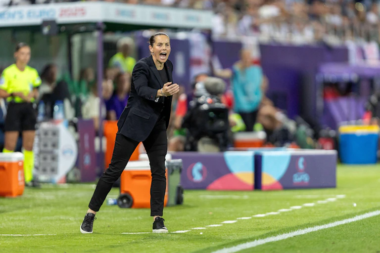 Rhian Wilkinson stands shouting on the touchline.