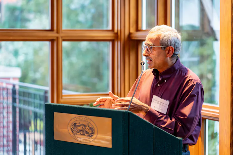 man standing at a podium, speaking