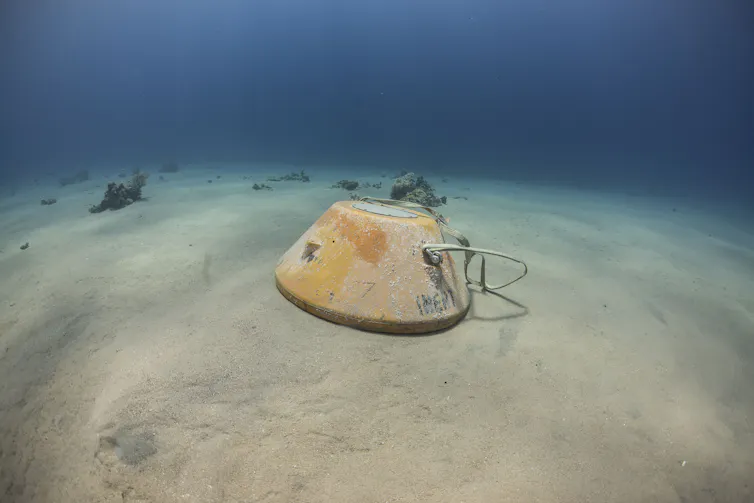 a conical object on a sandy seabed