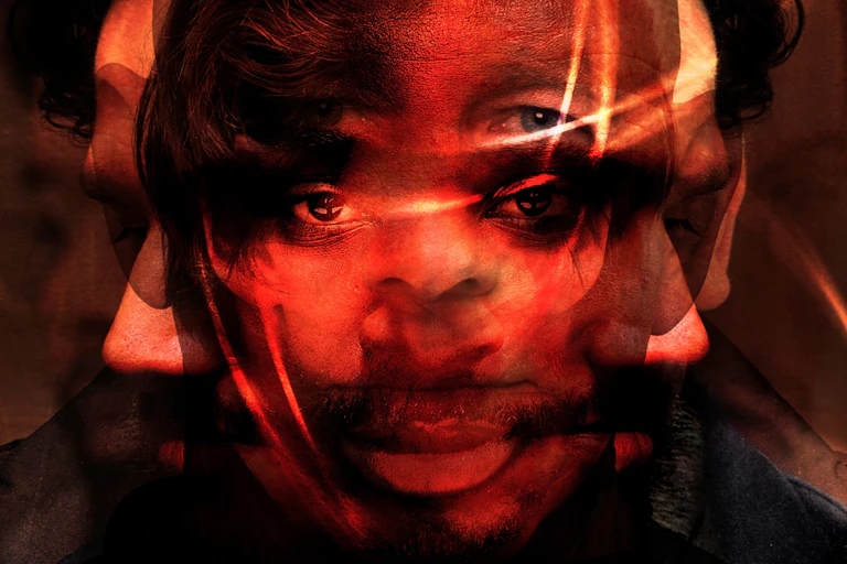 A graphic depiction of mental illness. The faces of multiple men have been overlaid one another. Each looks sad or anguished.
