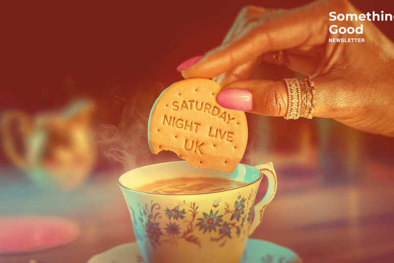 Woman dunking a biscuit that says Saturday Night Live Uk in a cup of tea.