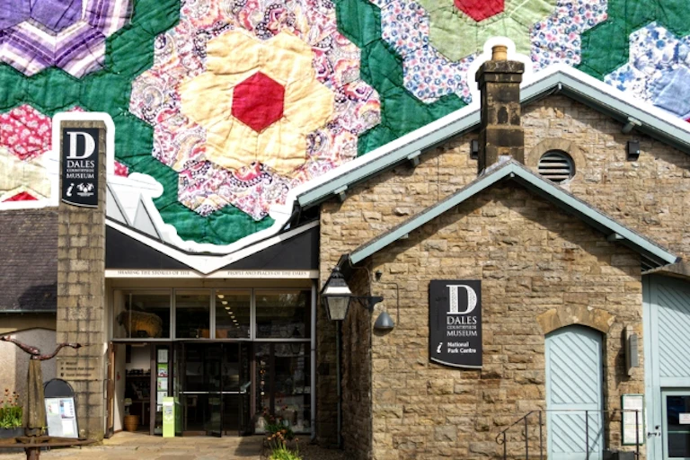 The Dales Countryside Museum collaged with a quilt in the background