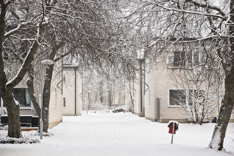 An image of two apartment blocks in Sweden on a snowy day.