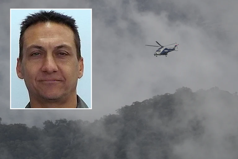 A headshot of Dezi Freeman is seen with a background of dense bushland and a police helicopter.