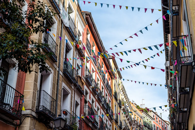 Edificios y banderolas en la calle que cruzan de un edificio a otro.