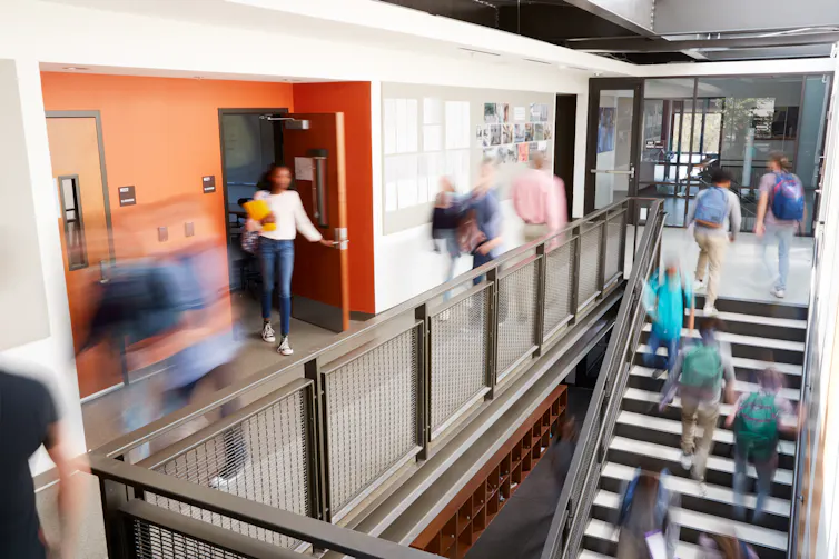 Blurred figures in school corridor