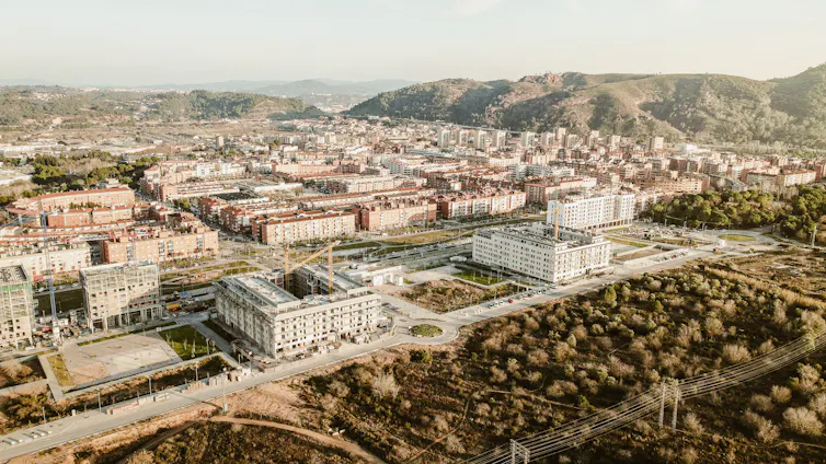 wide shot of Spanish landscape with eco community of buildings