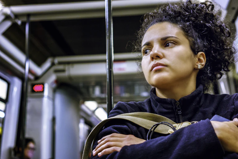 Worried girl sits on bus.