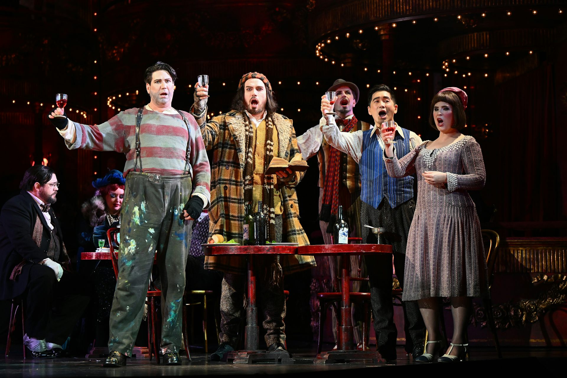 a performance of La Boheme, with actors in period dress singing and raising glasses