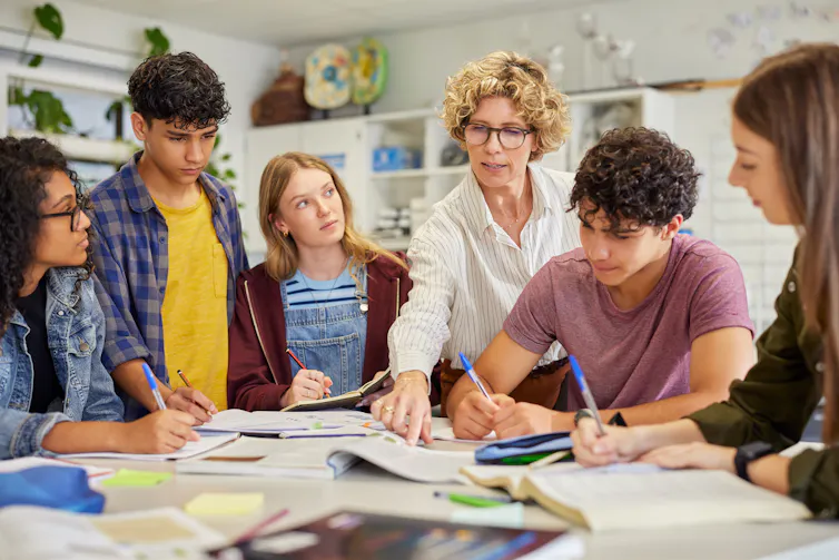Teacher talking to teenagers
