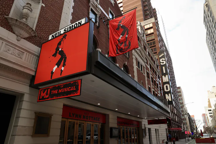 Banners for 'MJ The Musical' are seen hanging outside the Neil Simon Theatre in New York's Broadway district.